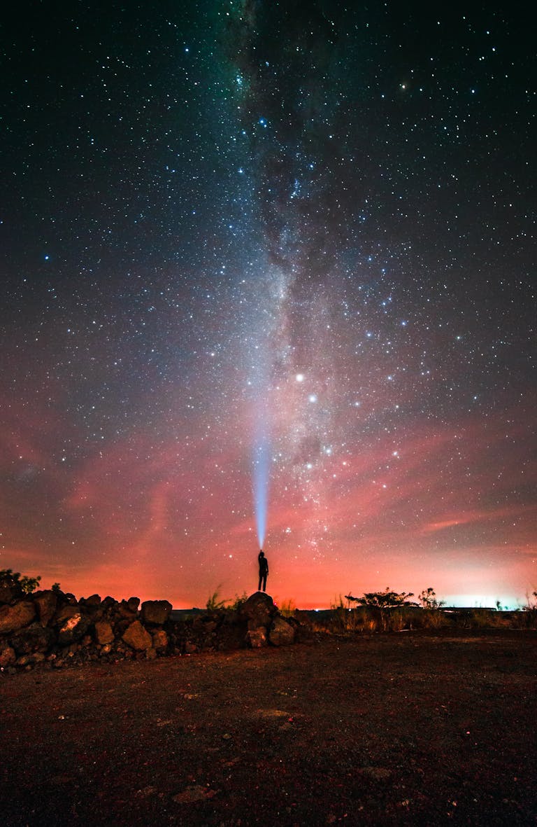 A person shines a light towards the Milky Way in the night sky over Brazil.